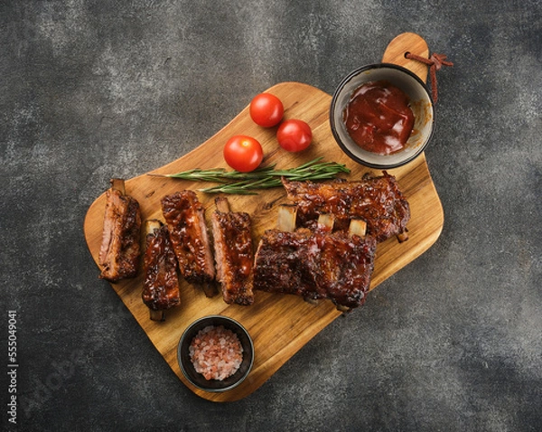 Fototapeta Delicious BBQ ribs. Smoked American style pork ribs with souce.