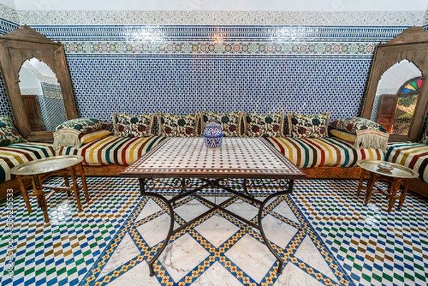 Fototapeta Beautiful traditional Moroccan salon with colorful mosaic tiles inside an old guest house in Morocco
