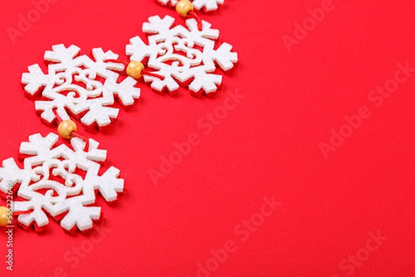 Fototapeta Christmas garland on a red background