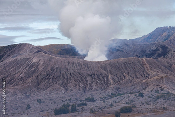 Fototapeta Mount Bromo with a puff of smoke from its caldera. Photographed with close up to see the natural details. The Bromo Tengger Semeru area is a popular tourist destination in East Java, Indonesia.