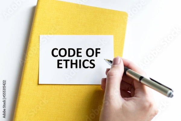 Fototapeta Businessman putting a card with text code of ethics