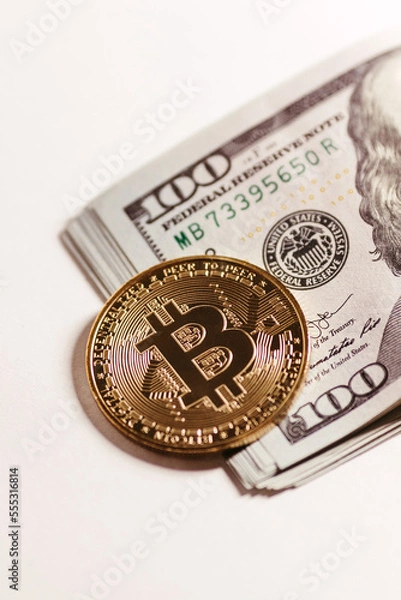 Obraz golden bitcoin coin with 100 dollar bills