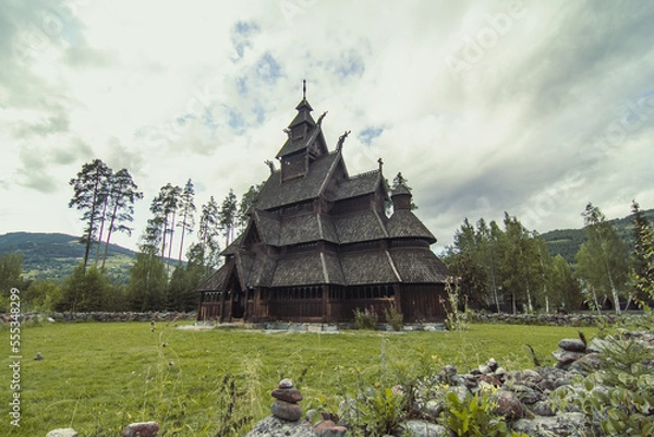 Obraz Urnes stavkirke at highland landscape photo. Beautiful nature scenery photography with cloudy sky on background. Idyllic scene. High quality picture for wallpaper, travel blog, magazine, article