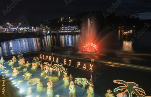 Fototapeta Christmas crib submerged and illuminated by colored lights in the water of Lake Maggiore in Laveno