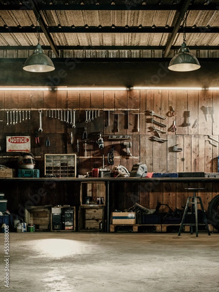 Fototapeta Workshop scene. Old tools hanging on wall in workshop, Tool shelf against a table and wall, vintage garage style