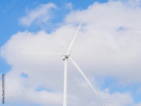 Fototapeta Close-up of Wind electric generator. Wind generators stand in agricultural fields with Powerful wind turbine farms for pure energy production on the background.	