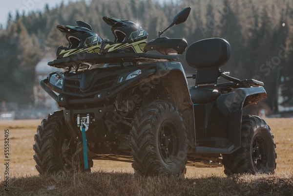 Fototapeta Beautiful nature landscape with ATV awd quadbike motorcycle and cloudscape sky background. Offroad adventure trip. Extreme sports activity. Front view. Concept motocross quadricycle background