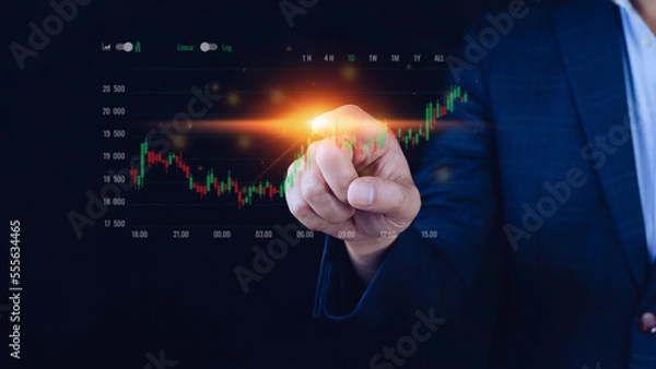 Obraz Businessman finger touch symbol stock graph and chart background, concept growth and development business investment, Stock market and strategy making market plan and stock market fluctuations