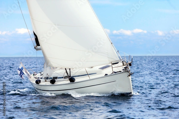 Fototapeta Sailing boat on open sea sailing on port tacks