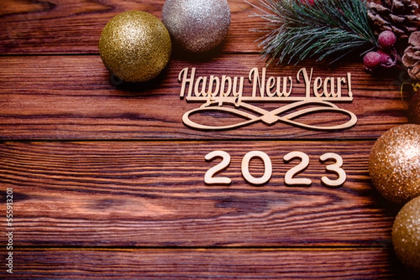 Fototapeta Happy new year 2023 on wooden brown background
