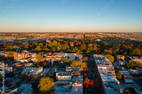 Fototapeta Aerial Drone View of Patterson Park in Baltimore City in Fall at Sunset with the City Skyline in the Distance