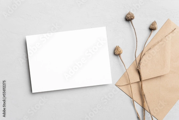 Obraz Blank wedding invitation card mockup with envelope and dry plant decor. Flat lay, top view, copy space