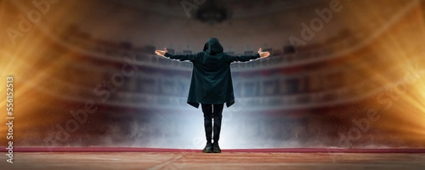 Fototapeta Professional male actor on the stage of the theater against the background of an empty hall