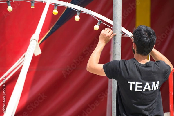 Fototapeta man at work event, organization, organizer, concert, festival, team, security, organizing, assistant, activity, voluntary, music festival, organiser, job, camp, live, open air, party, club, perform,