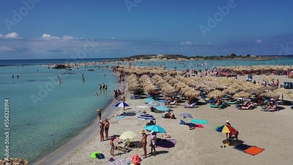 Fototapeta People relaxing on the famous pink coral beach of Elafonisi on Crete in sunny summer day