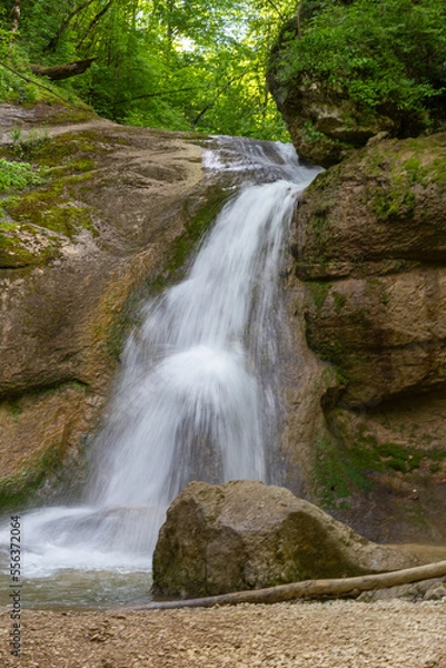 Obraz A mountain river in a natural channel with rapids and waterfalls.