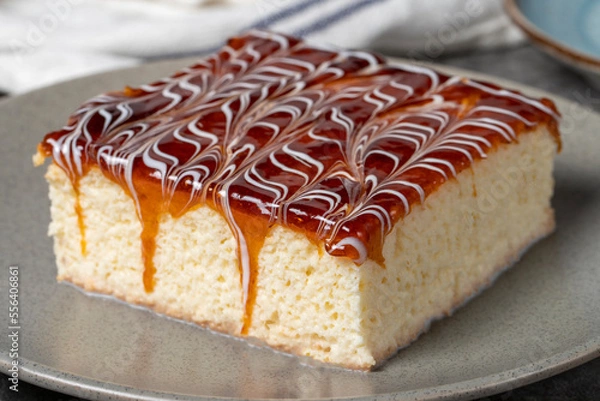 Fototapeta Trilece cake slice on dark background. Milk and caramel cake. Bakery products. Mexican sweets. close up