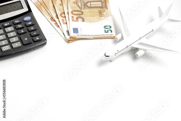 Obraz Airplane calculator and euro banknotes on a white background. Planning a vacation concept