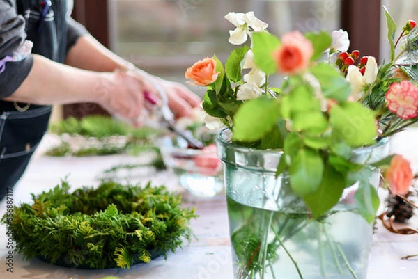 Fototapeta 生花を使った華やかなフラワーアレンジメント　手作りの花のリース　女性フラワーデザイナー