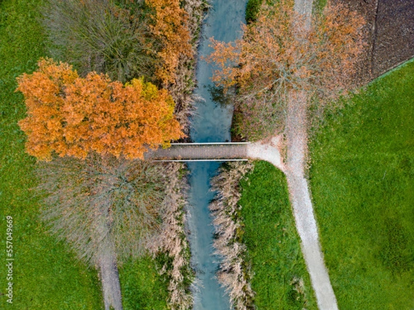 Obraz Aerial view of foot bridge over a stream in autumn