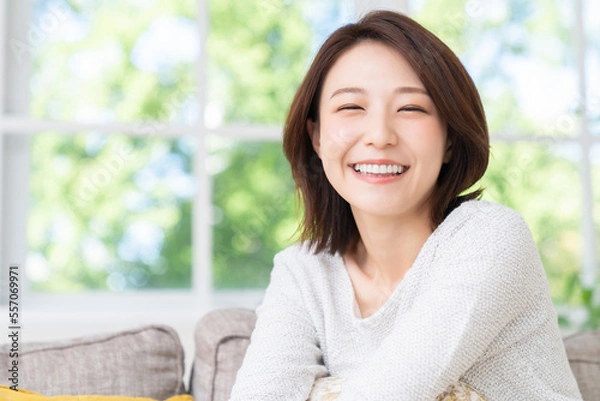 Fototapeta 部屋でリラックスする若い女性