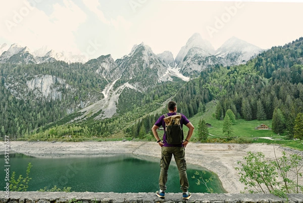 Obraz Back of man with backpack against lake and mountains at Vorderer Gosausee, Gosau, Upper Austria.
