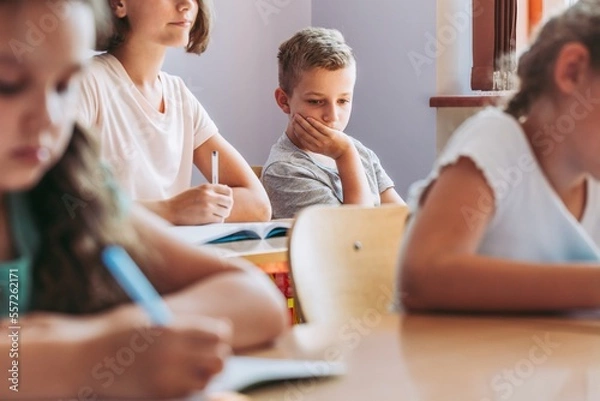 Fototapeta Sad boy in classroom