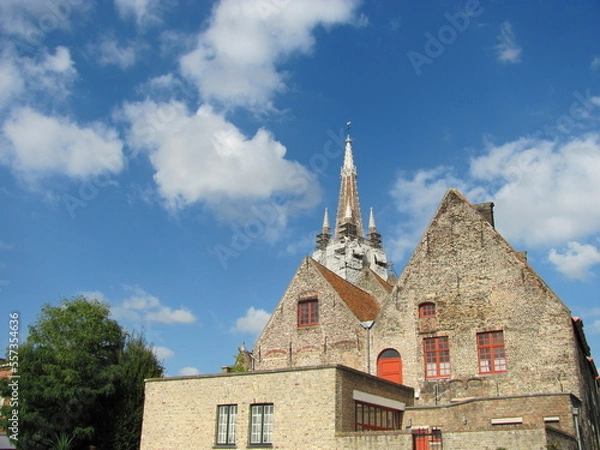 Fototapeta red window barn like building with tower in background
