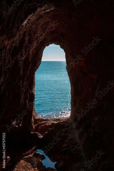 Fototapeta View from the cave along the ocean