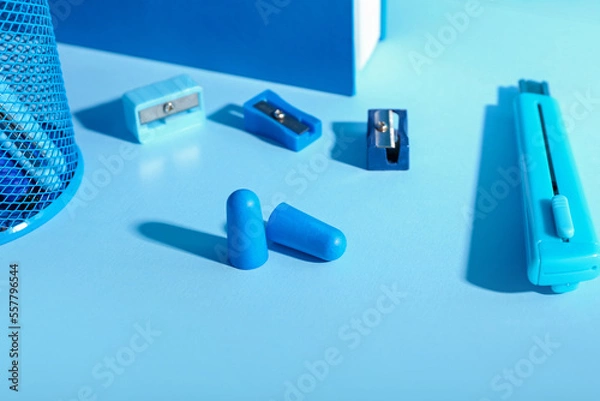 Obraz Foam earplugs and stationery on blue background