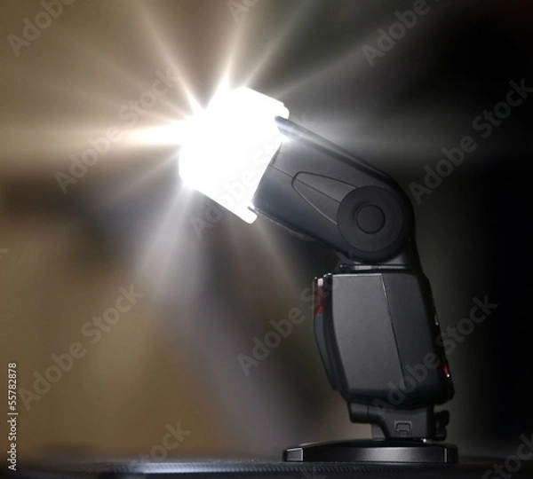 Fototapeta Camera flash or speedlite firing.