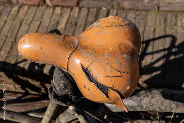 Obraz A weathered and torn bike seat of an abandoned bicycle in Delft, Netherlands