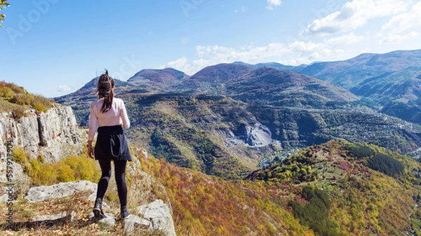 Fototapeta Traveler Woman standing on a rocks  in the autumn  mountain . Balkan mountains,  ,Bulgaria