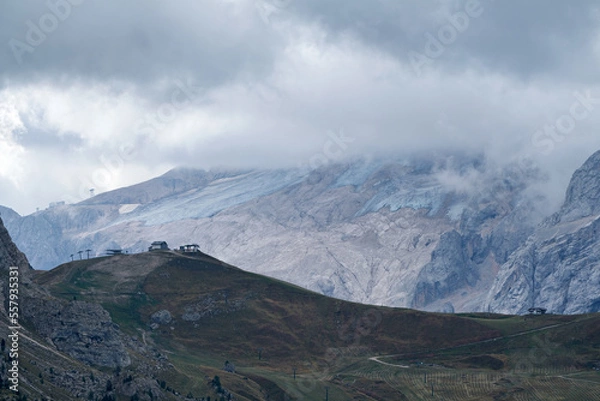Fototapeta Great view of the Dolomites mountains with the glacier of the Marmolada in the background and a fantastic light and clouds condition, South Tyrol, Italy