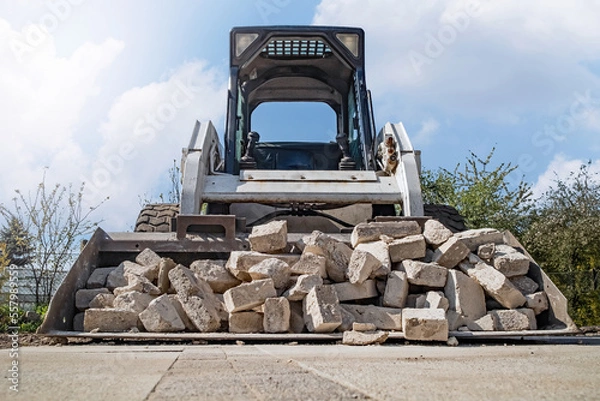 Fototapeta Mini loader on wheels during heavy construction work.
Mini ładowarka na kołach podczas ciężkich prac budowlanych.