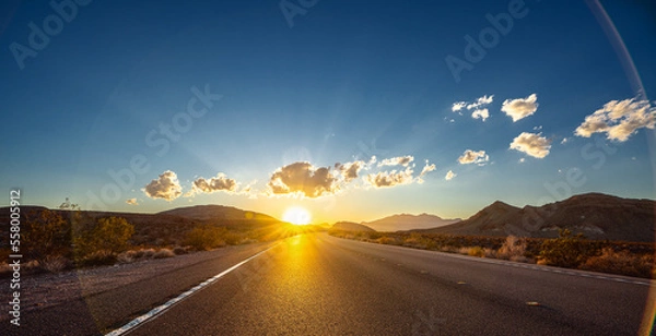 Fototapeta Empty long nevada mountain road to the horizon on a sunny summer day at bright sunset