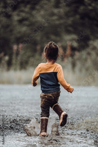 Fototapeta Toddler playing in water