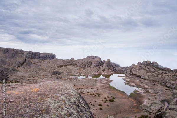 Obraz a lagoon and a valley with rocks in the background