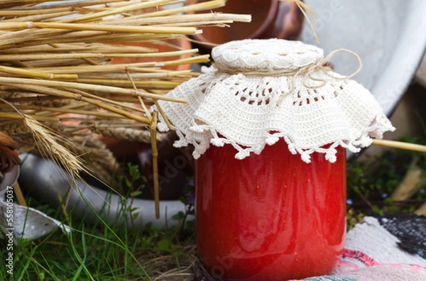 Obraz Rustic food concept. Natural tomato juice in a glass jar on country fair