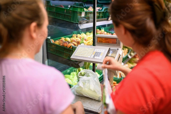 Fototapeta person calculating weight in supermarket