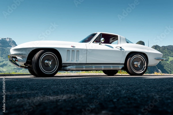 Fototapeta This classic American muscle car with a white paint job is pristine, powerful lines are sure to turn heads. With its iconic design, it's perfect for adding a touch of classic style to your project