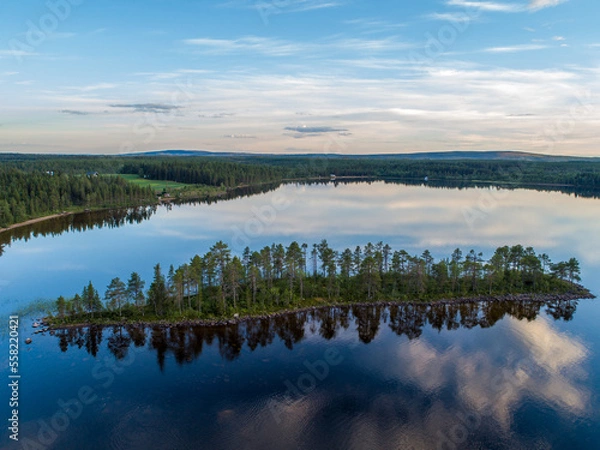 Fototapeta Aerial View Small Island in the Sandsjön Lake in Sandsjönäs, Swedish Lappland during Sunset with reflections in the water