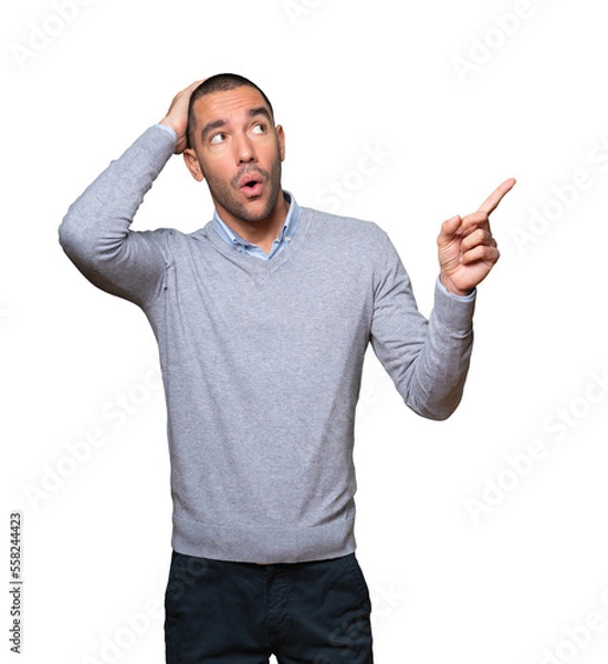 Obraz Cool young man pointing with his finger