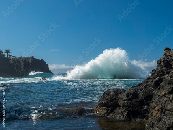 Fototapeta View of natural rock swimming pool Charco de Isla Cangrejo in the Atlantic Ocean in Los Gigantes, Tenerife, Canary islands, Spain. Sunny winter day.