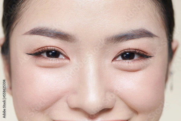 Fototapeta A half of a beautiful female's face with eye bags