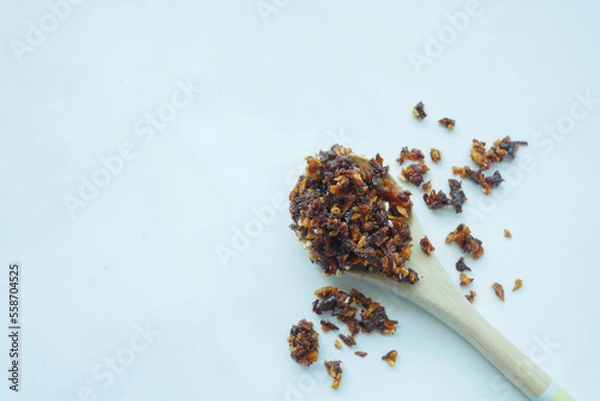 Obraz chili and garlic flakes on a wooden spoon on white background 