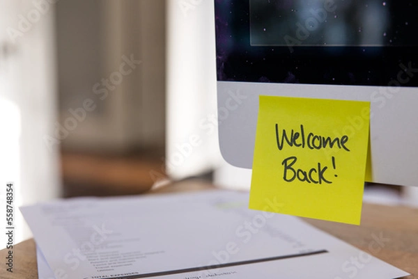 Fototapeta Welcome back post it note on computer, yellow sticky note, office welcome back note