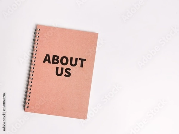 Fototapeta Concept of about us. Top view notebook cover written about us.