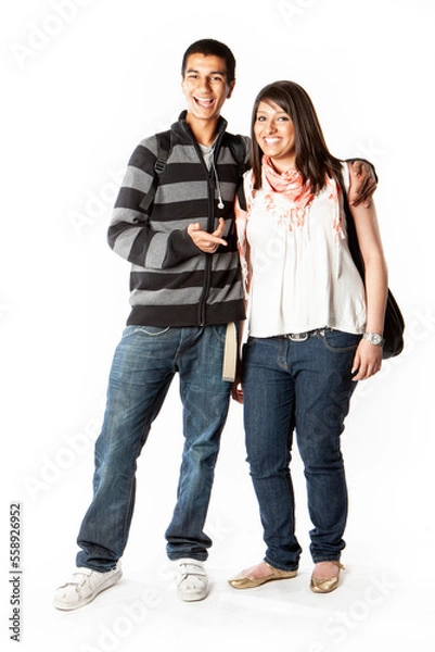 Fototapeta Teenage Students: Good Friends. Happy smiles from a pair of late teenage Indian school friends isolated on white. From a series of related images.