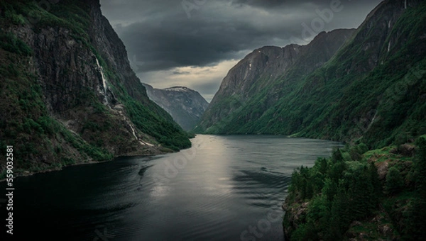 Fototapeta Moody fjord with mountains and waterfall of Aurlandsfjord at Gudvangen in Norway, dark clouds in the sky, from above